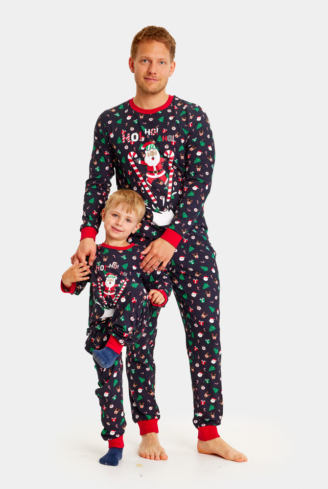 Christmas Pyjama Family and Children with Skiing Santa